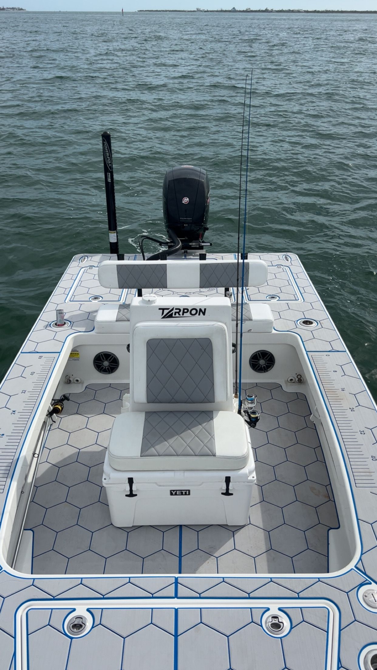 A white boat is floating on top of a body of water.