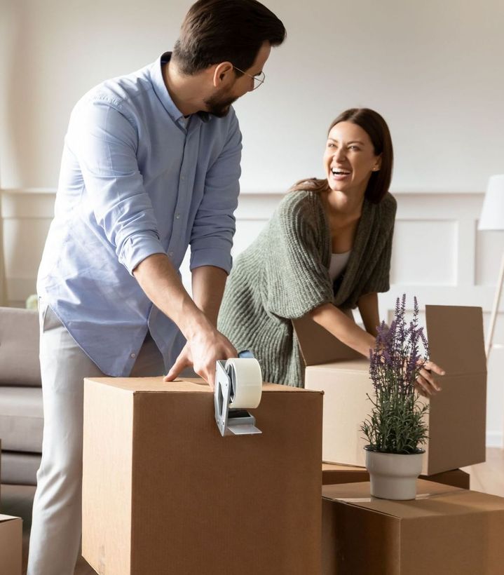 Couple packing moving boxes