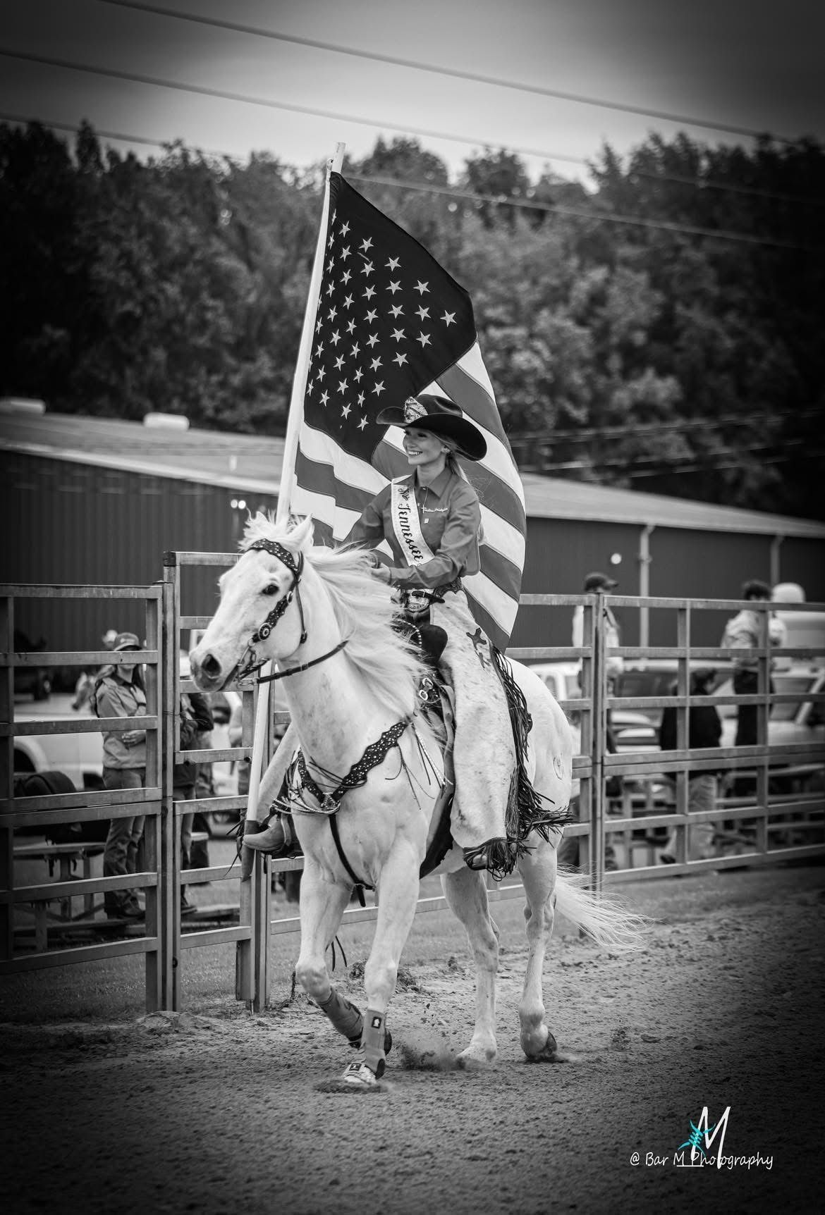 A man is riding a brown horse in a field.