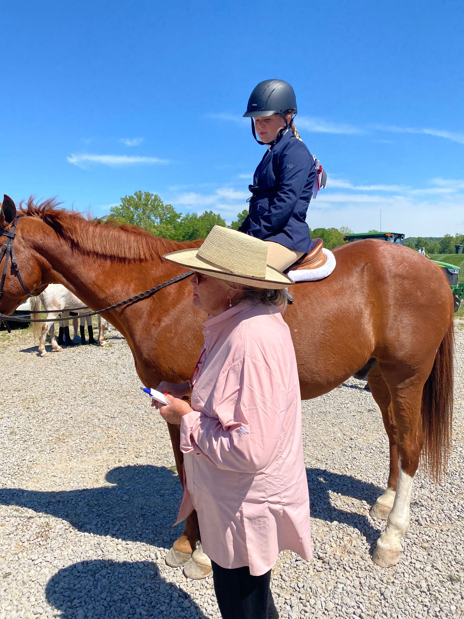 A woman wearing a helmet is holding two ribbons that say iea