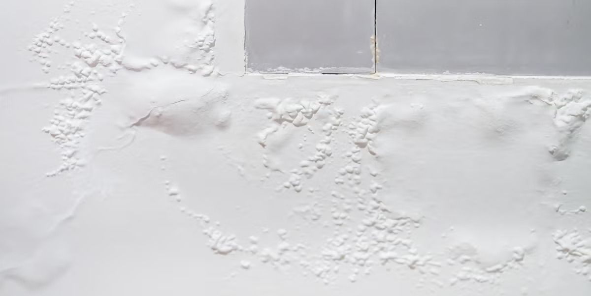 Hidden water damage behind kitchen cabinet drywall