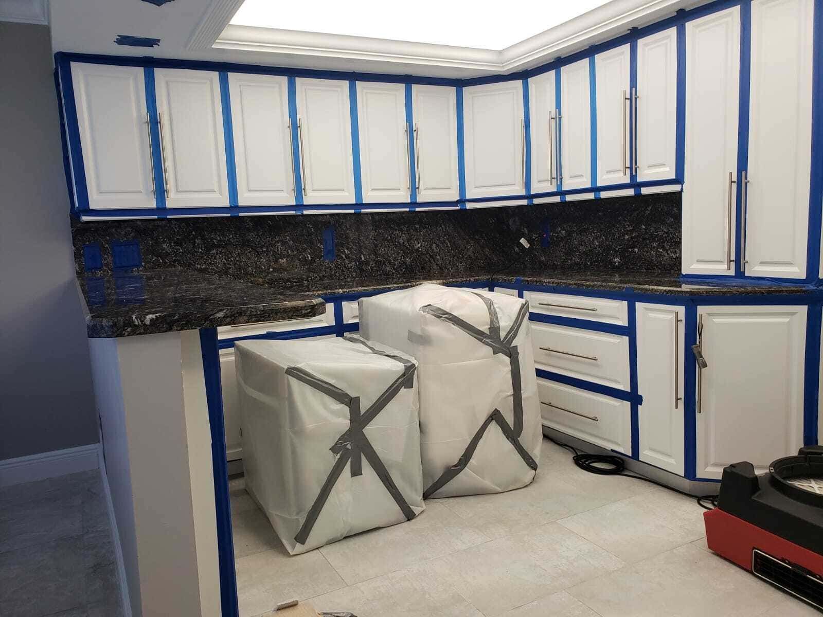 Mold remediation in Fort Myers kitchen – professional team removing mold under cabinets