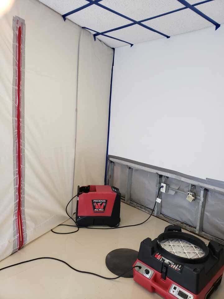 Professional water extraction equipment removing moisture during kitchen mold restoration in Fort Myers home.