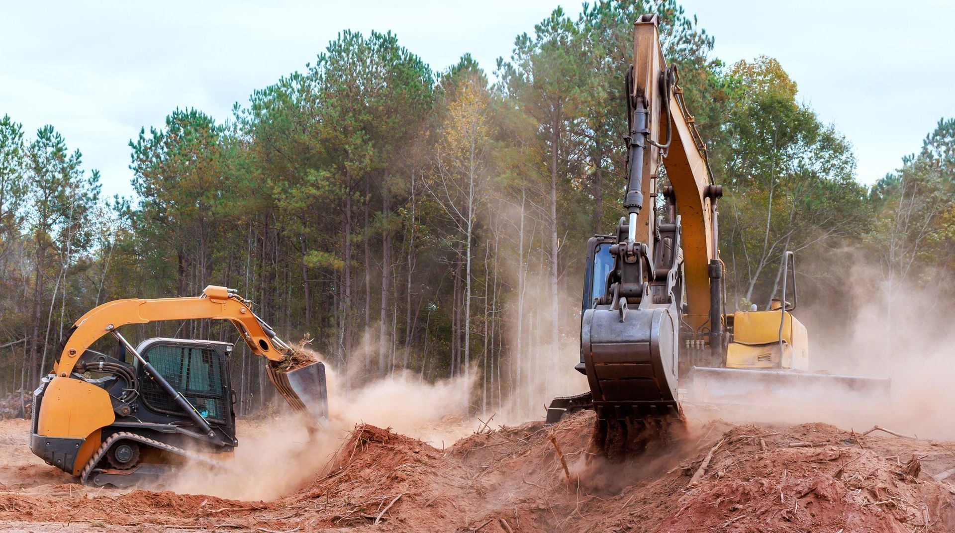 “Excavator clearing fallen branches, wood debris, and brush from a property during tree services”
