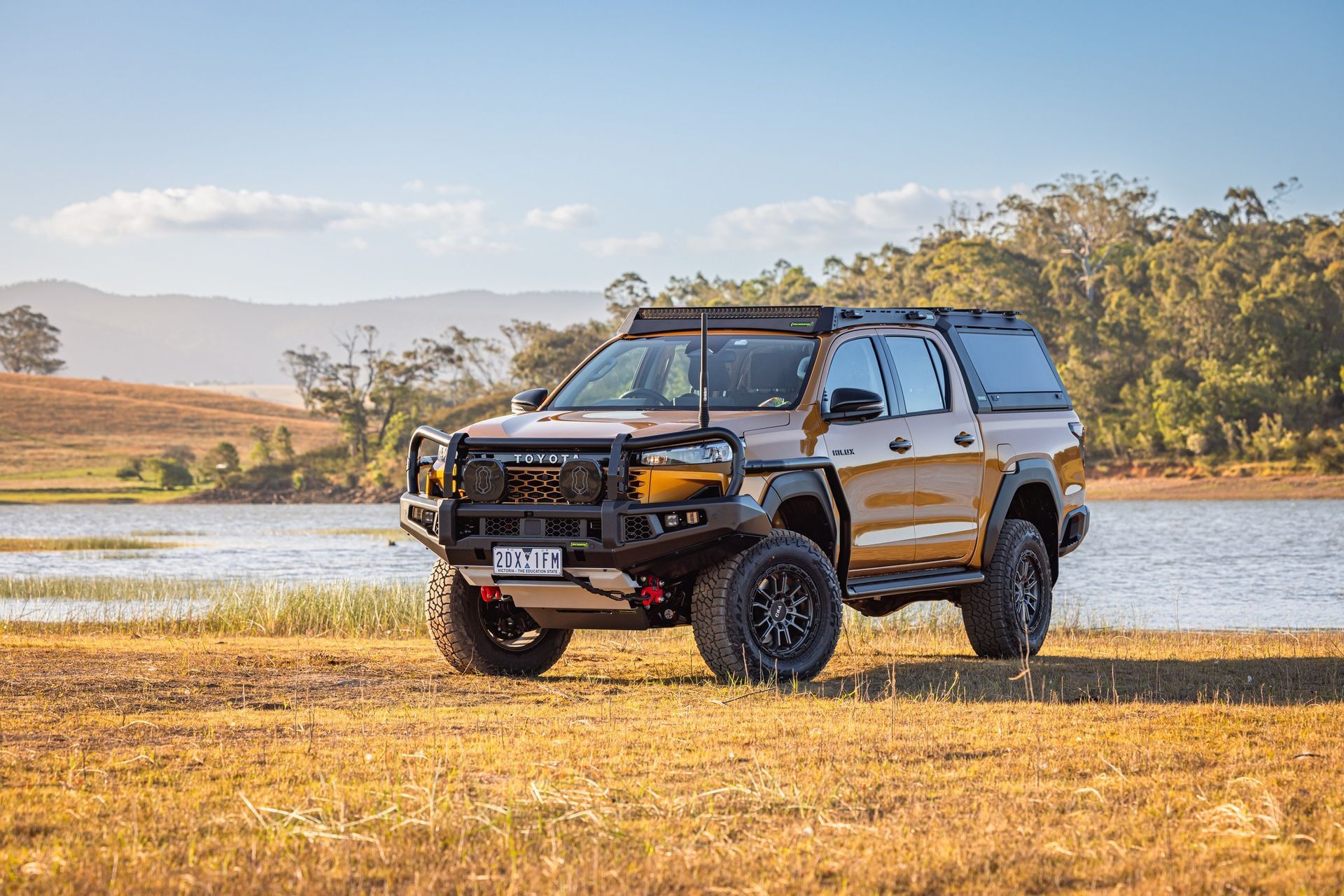 Rugged 4x4 Truck Parked Near Lake With Hills