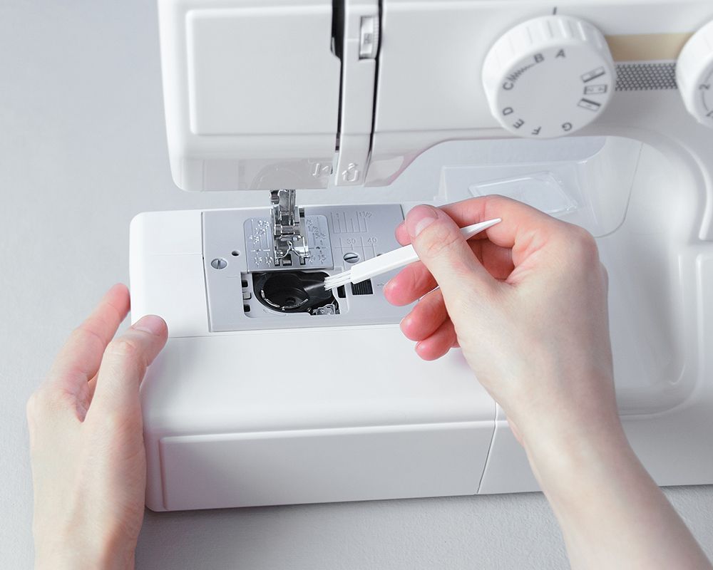 Cleaning the Sewing Machine Using Brush — Grand Junction, CO — Hi Fashion Sewing Machines