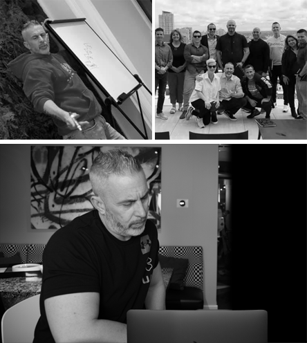 A man is sitting in front of a laptop in a black and white photo