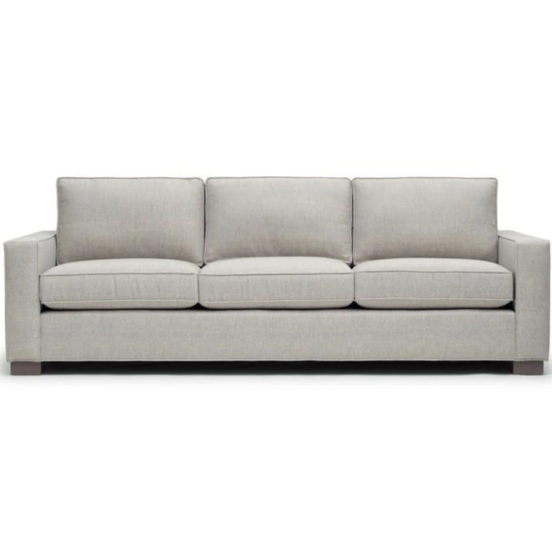 Beige three-seat sofa with square arms and three back cushions, on a white background.