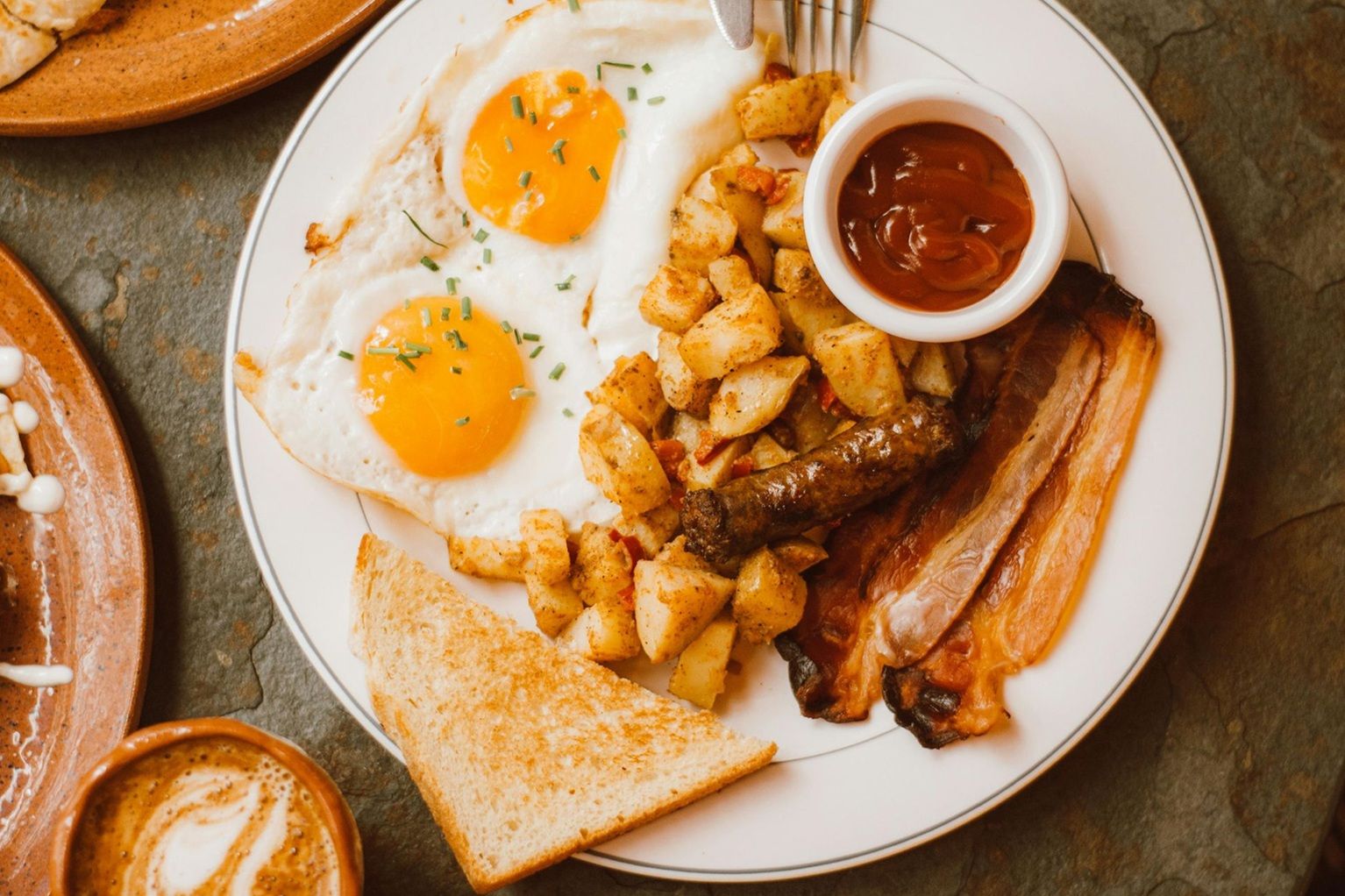 The inside of a church with rows of benches and a large window.