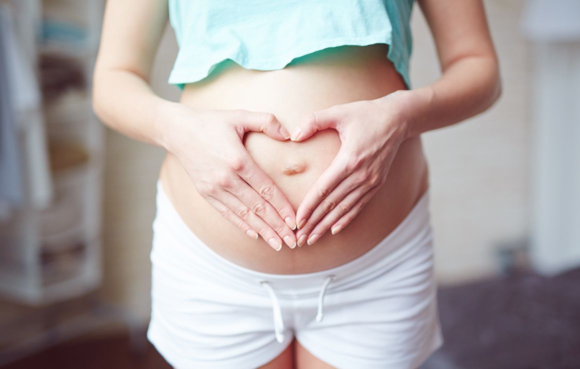 The inside of a church with rows of benches and a large window.