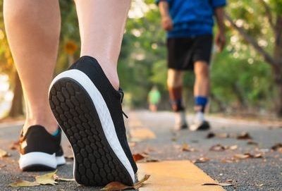 The inside of a church with rows of benches and a large window.
