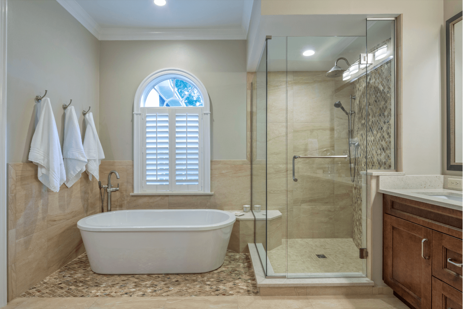 A bathroom with a tub and a walk in shower.