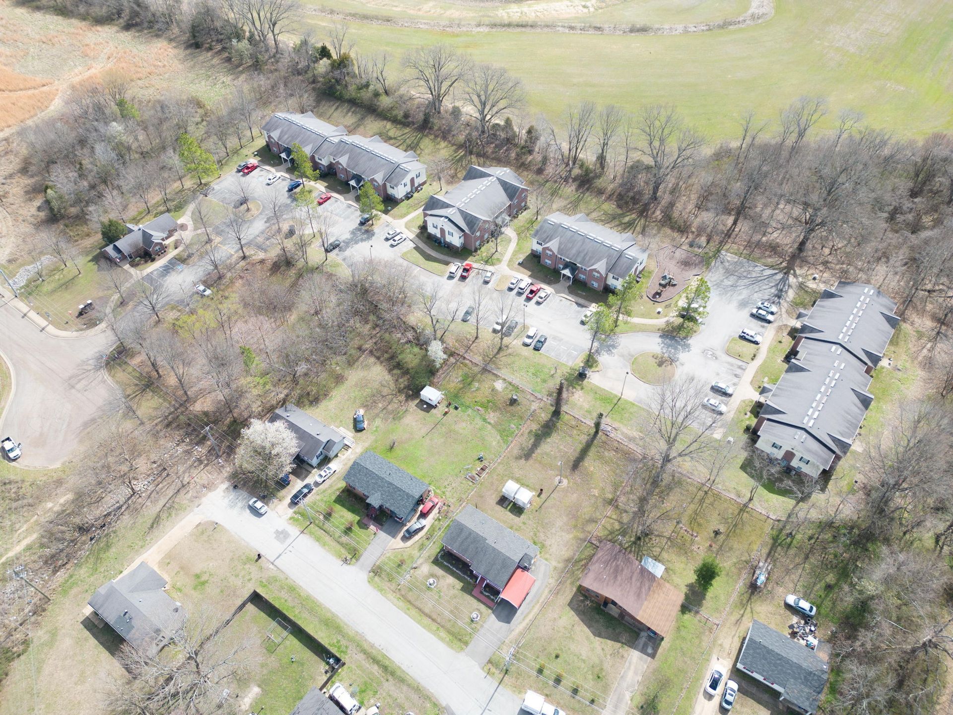 An aerial view of a residential area with lots of houses and trees.