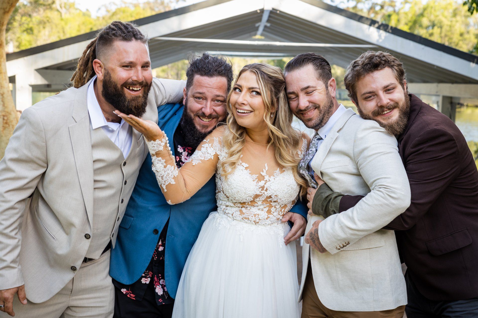 Wedding Video - a bride and groom are posing for a picture with their wedding party .