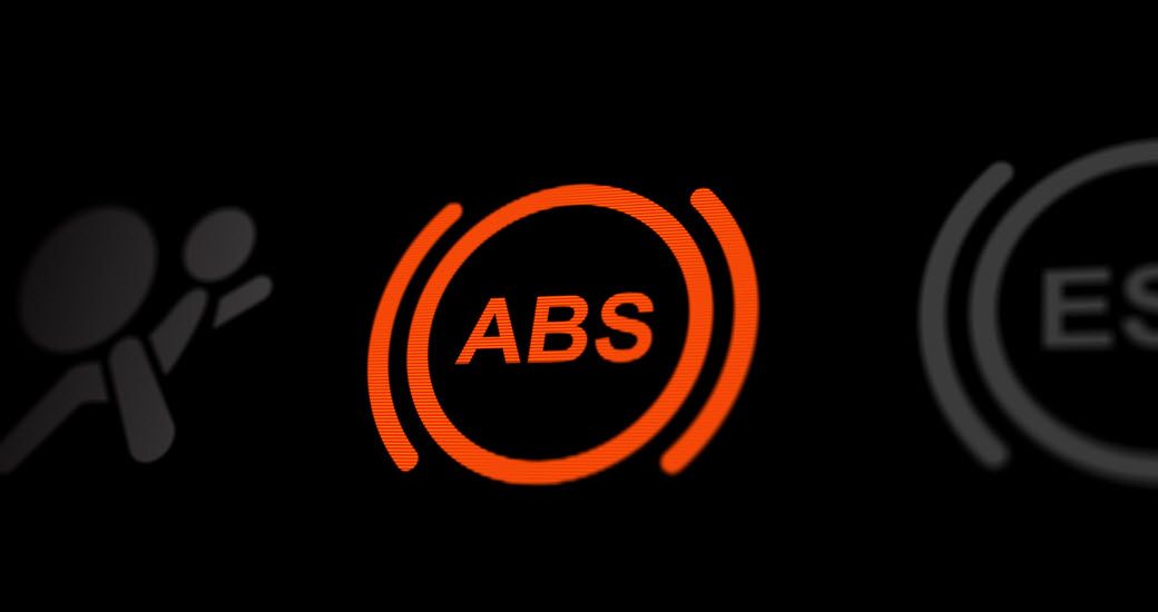 Up close to orange ABS warning light on dashboard | Crowne Automotive