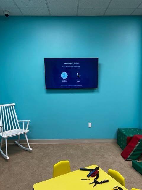 A blue wall with a flat screen tv on it