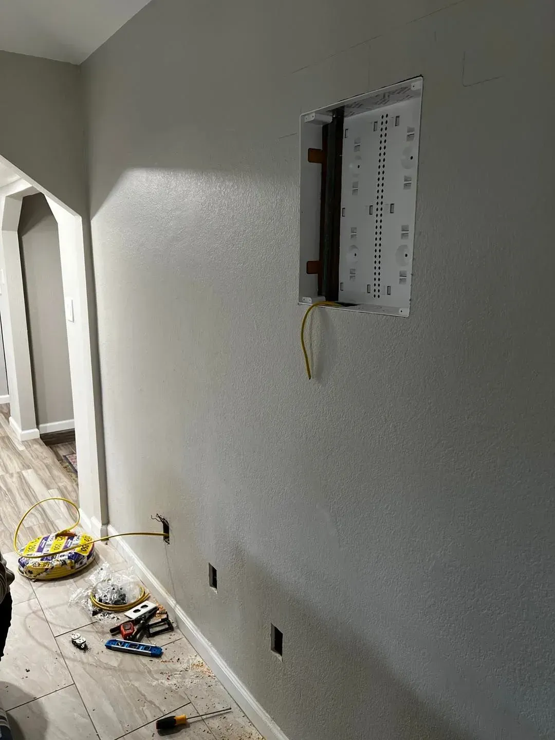 A wall with a hole in it and a box in it.