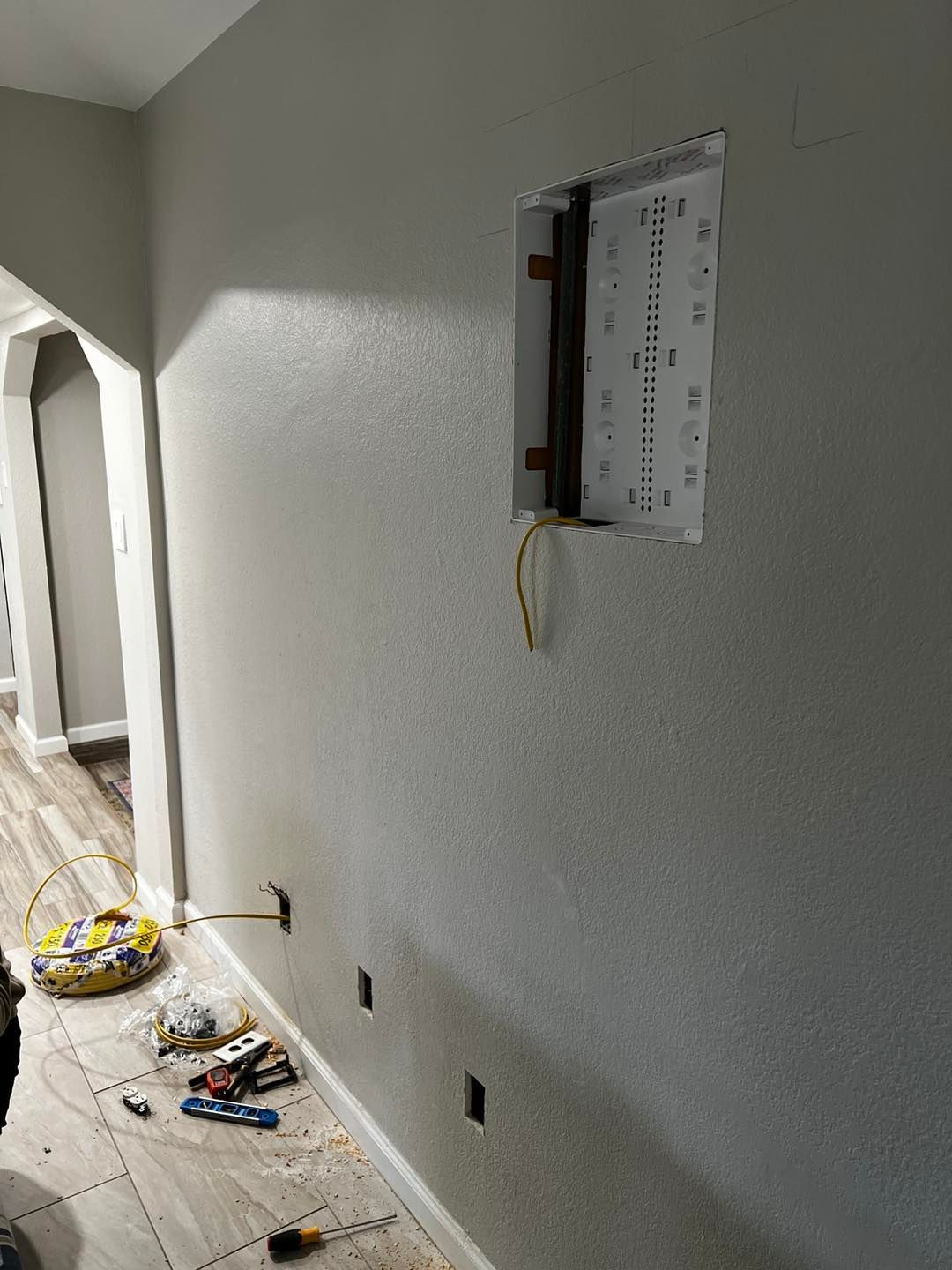 A wall with a hole in it and a box on it.