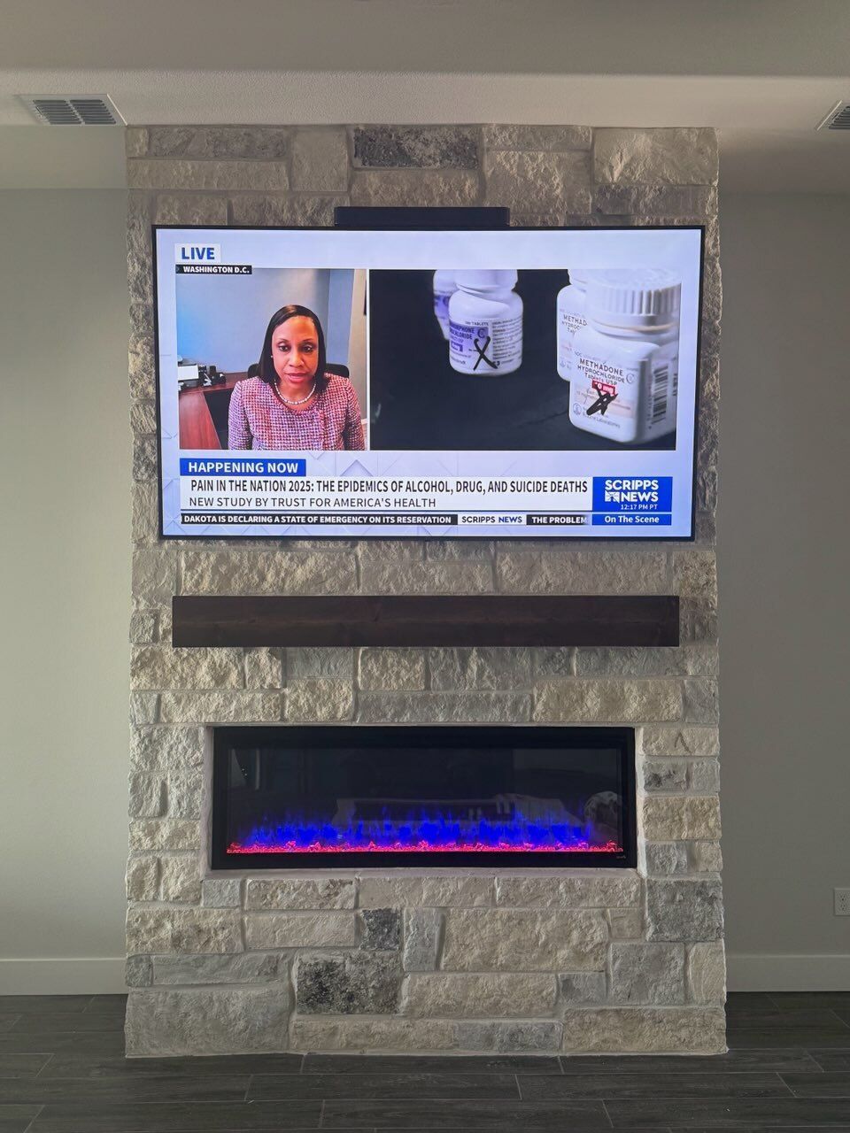 A fireplace with a flat screen tv above it.