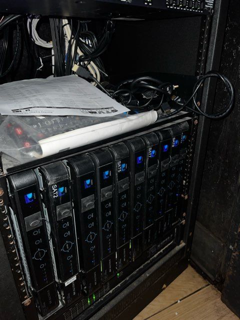 A bunch of servers are sitting on top of each other on a rack.