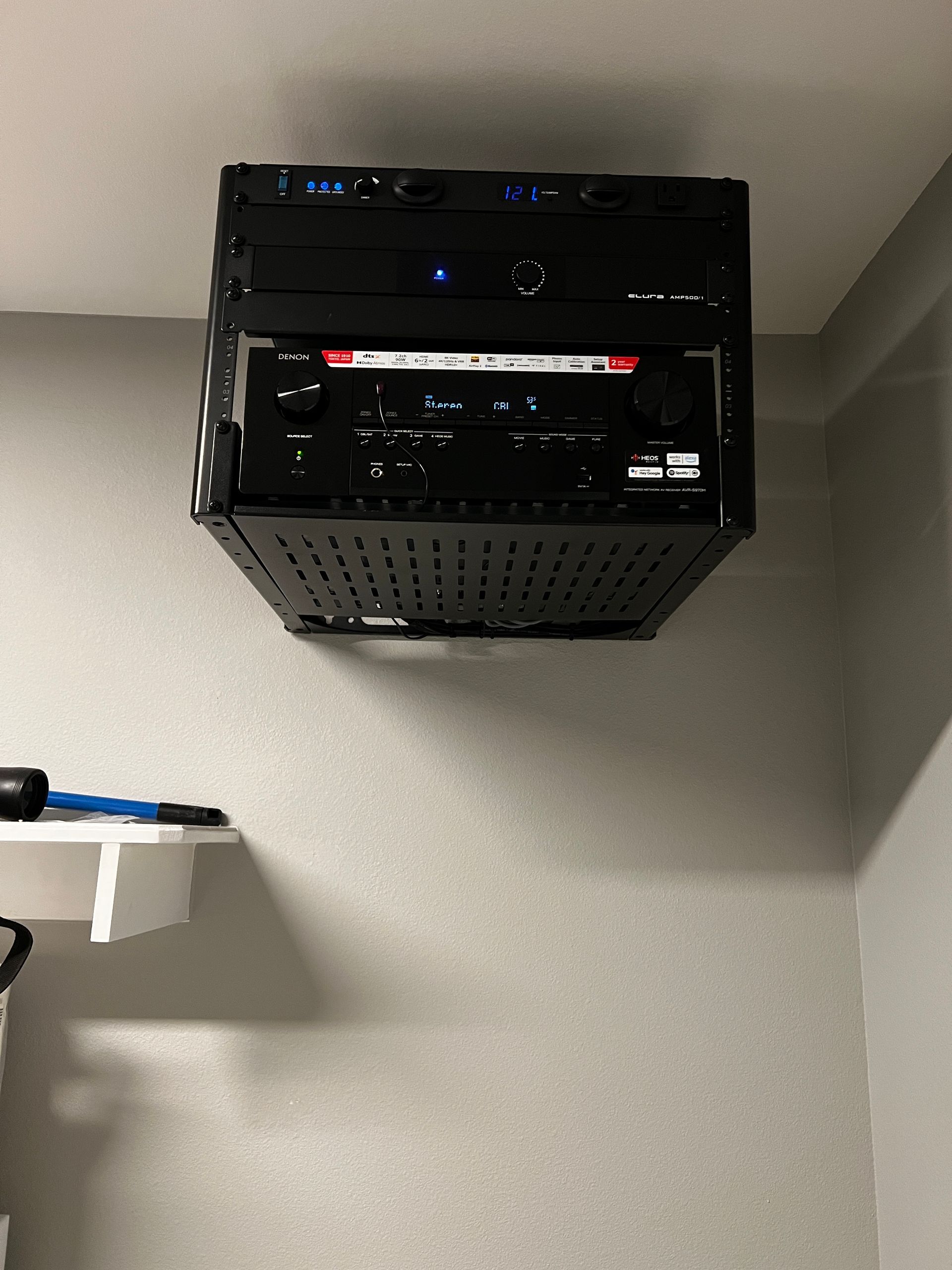A black box is hanging from the ceiling in a room