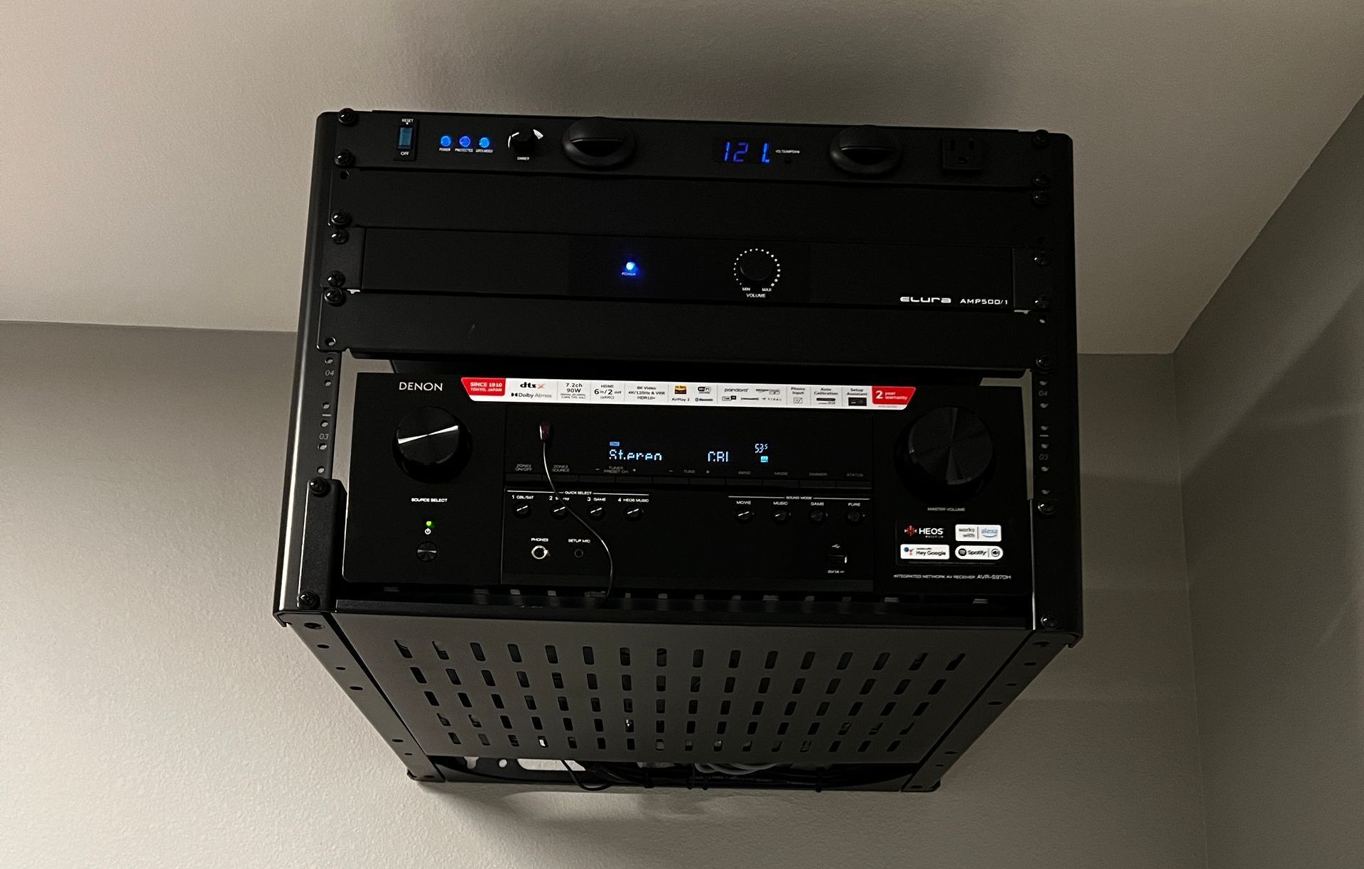 A computer sitting on top of another computer on a wall