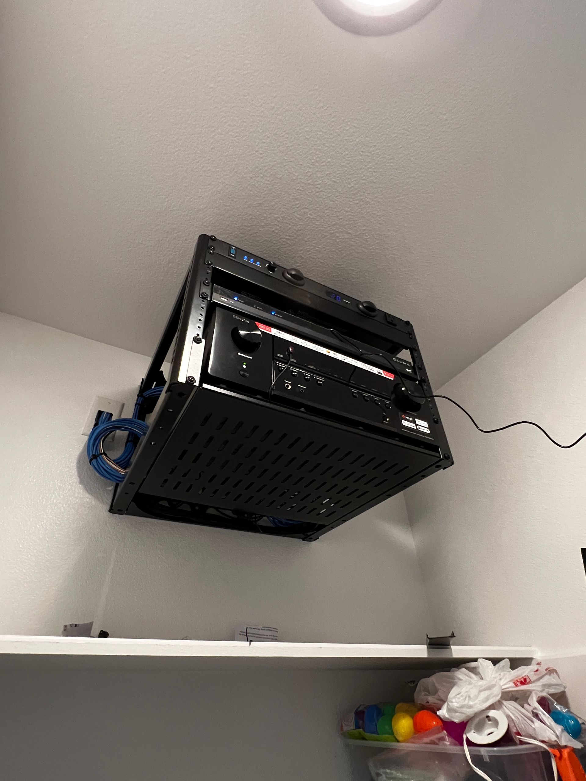 A black box is hanging from the ceiling in a room.