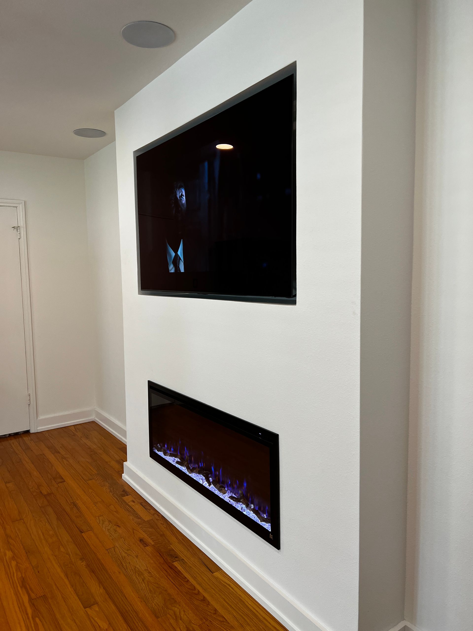 A living room with a fireplace and a flat screen tv