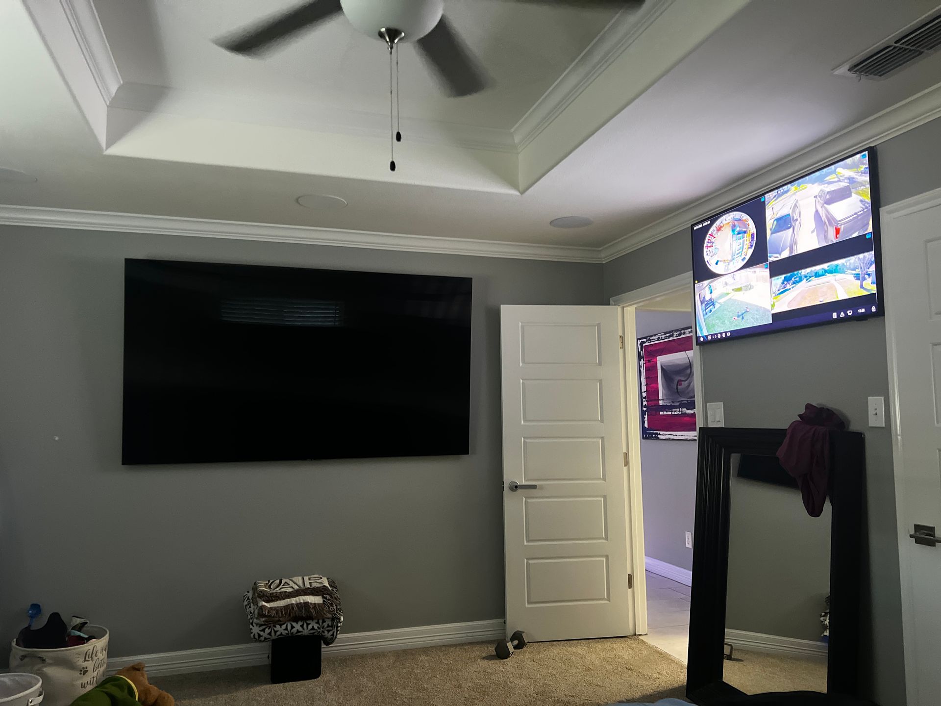 A living room with a large flat screen tv on the wall.