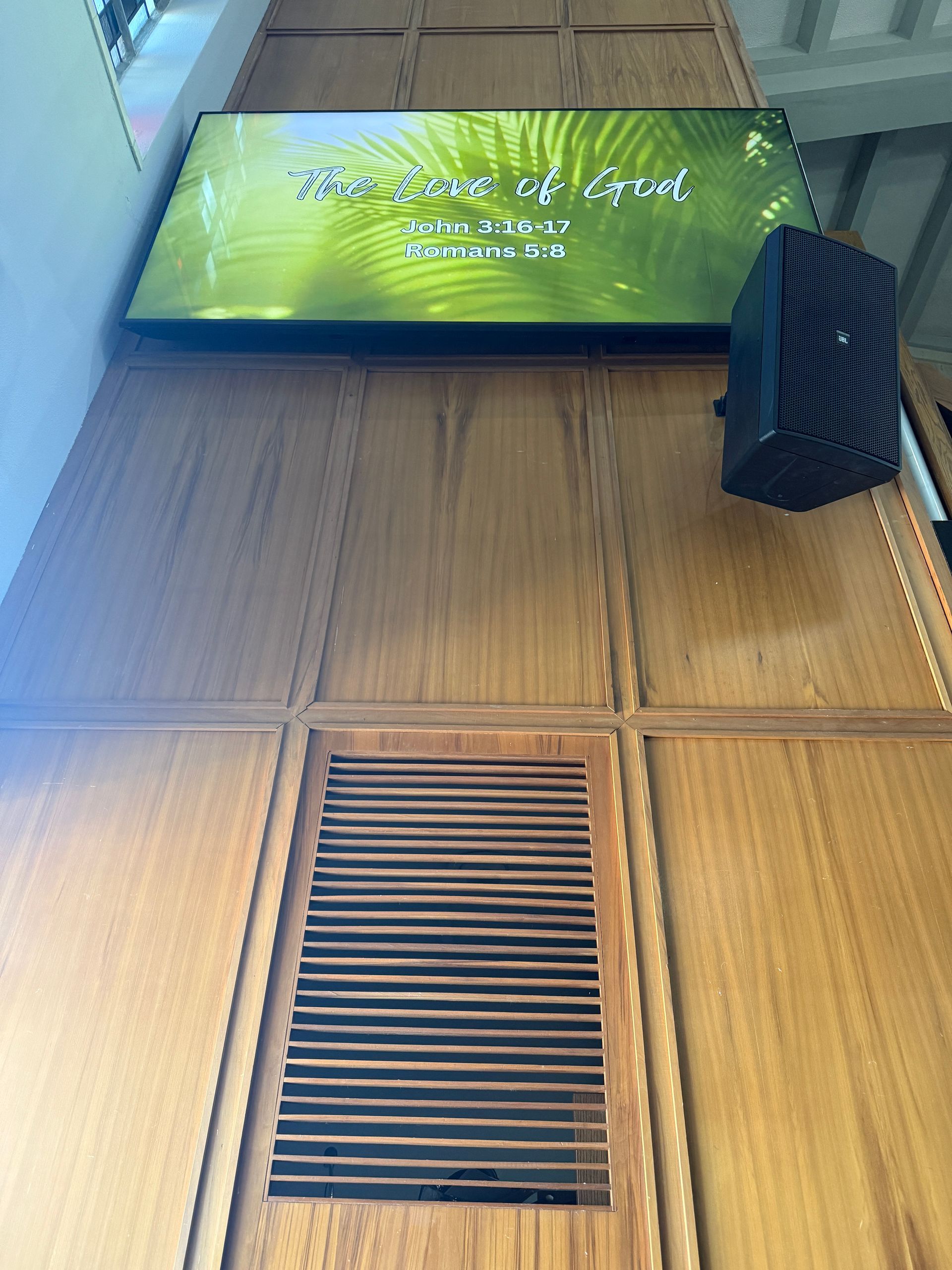 A sign on a wooden wall that says 