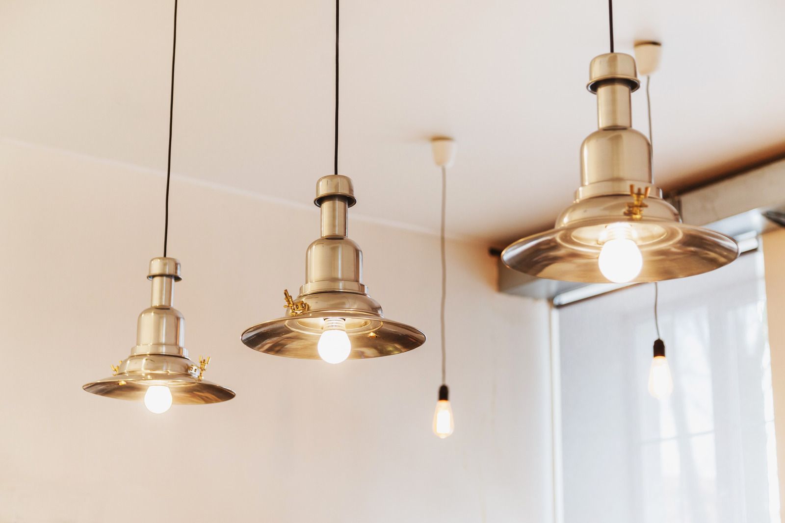 Three pendant lights are hanging from the ceiling in a room.