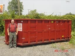 Man Beside Dumpster — Dumpster Rentals in Columbus, OH