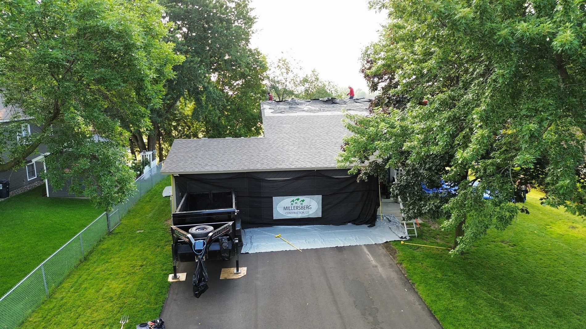 Black tent covering a garage; a truck is parked in front.