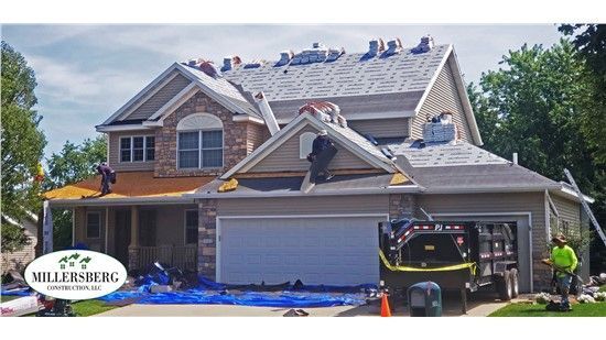 House under roof construction with workers; Millersberg logo.