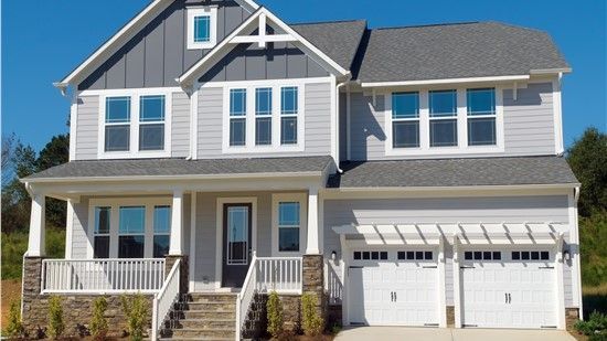 Two-story house with gray siding, white trim, and a two-car garage.