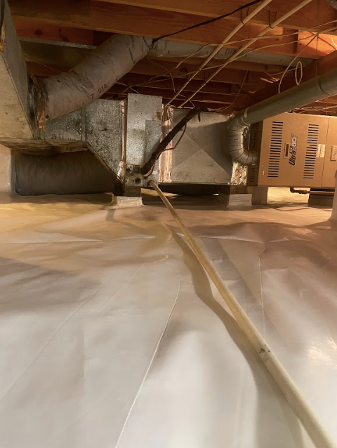 A basement with a box on the floor and a box on the ceiling.