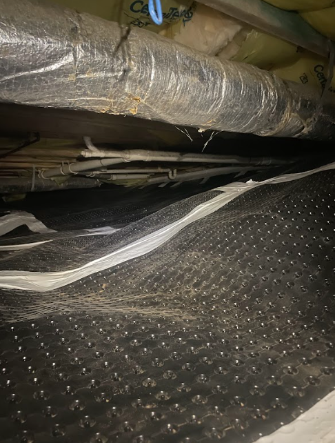 A bunch of pipes are hanging from the ceiling of a room.