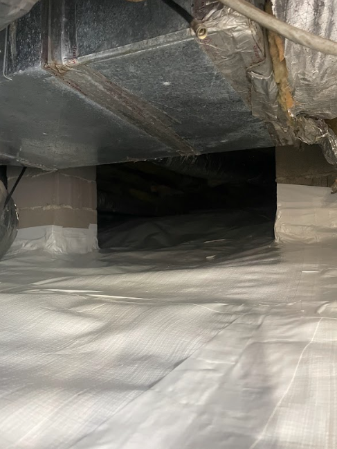 A close up of a duct in a basement.