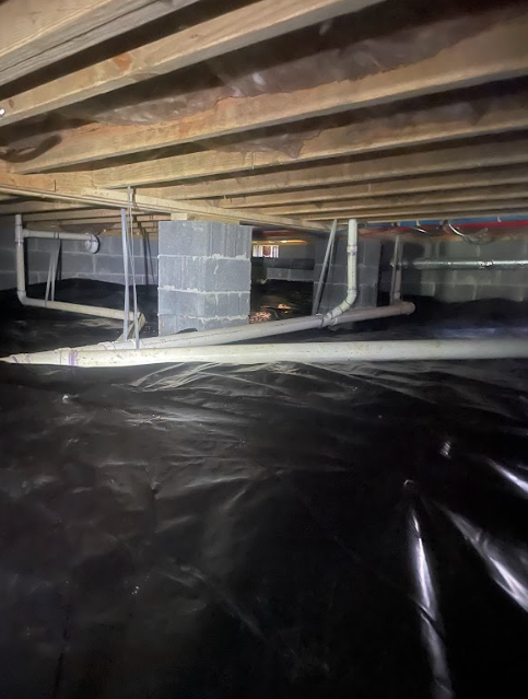 A basement with a lot of pipes coming out of it.