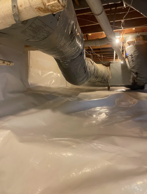 A basement with a lot of pipes coming out of it.