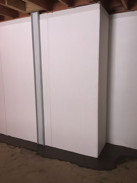A row of white cabinets in a room with a wooden ceiling