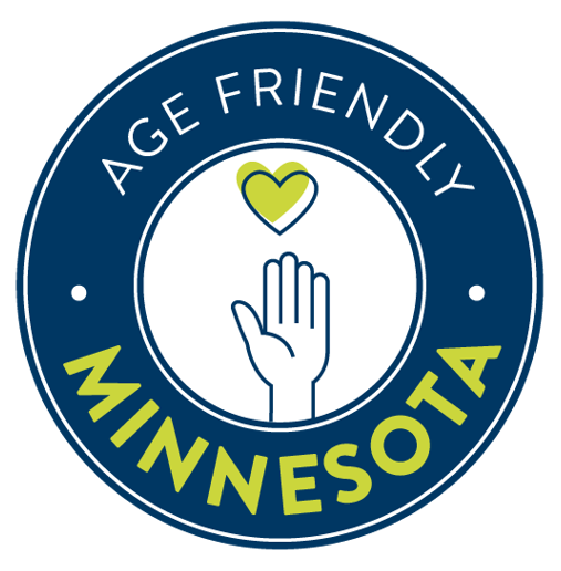 A blue circle with the icon of a hand with a green heart in the center. The words Age-Friendly Minnesota encircle the icon