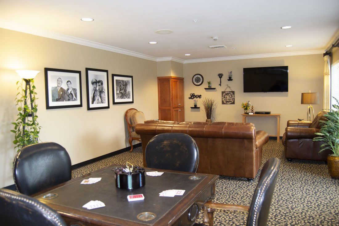 A living room with a table and chairs and a television