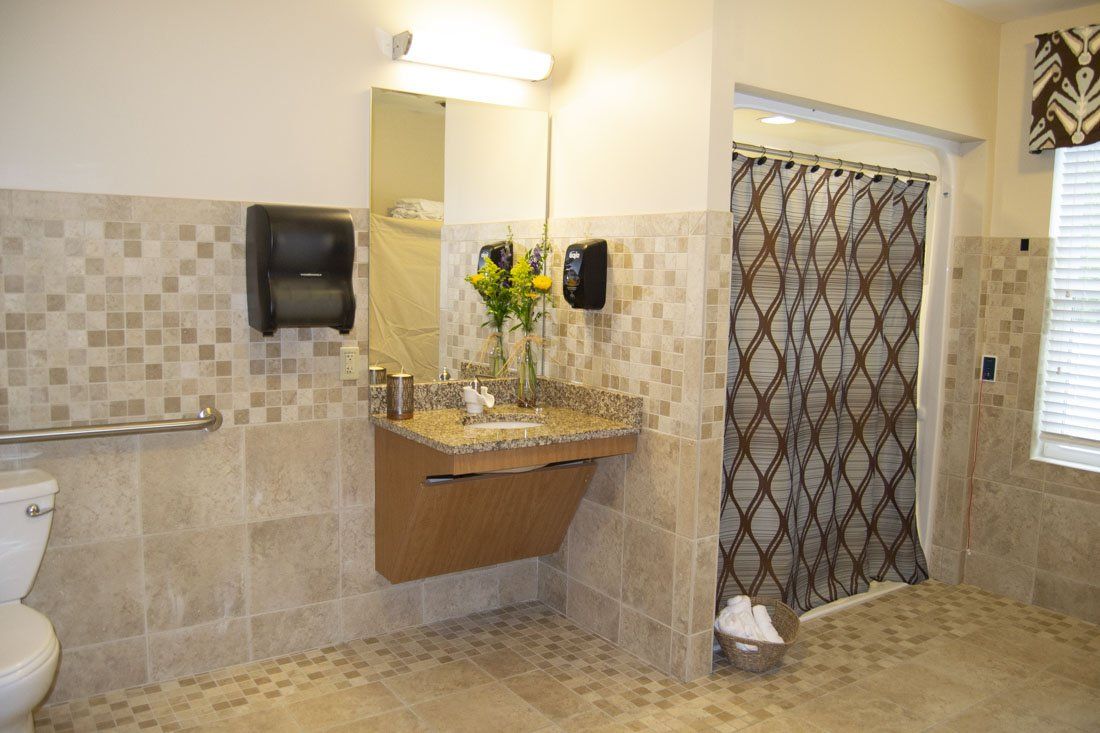 A bathroom with a sink , toilet and shower.