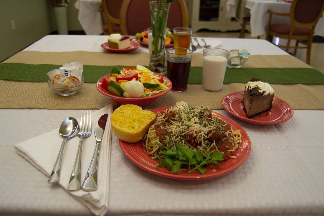 A table with plates of food and utensils on it