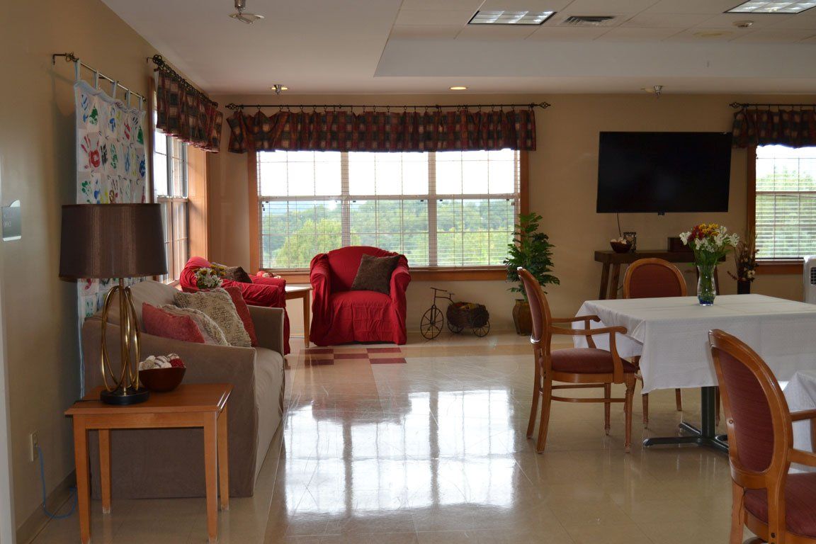 A living room with a couch a chair a table and a television