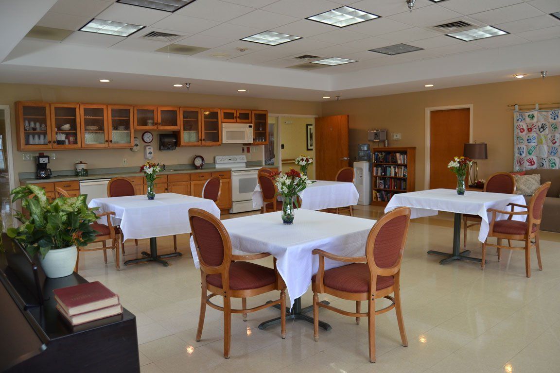 A large room with tables and chairs in it
