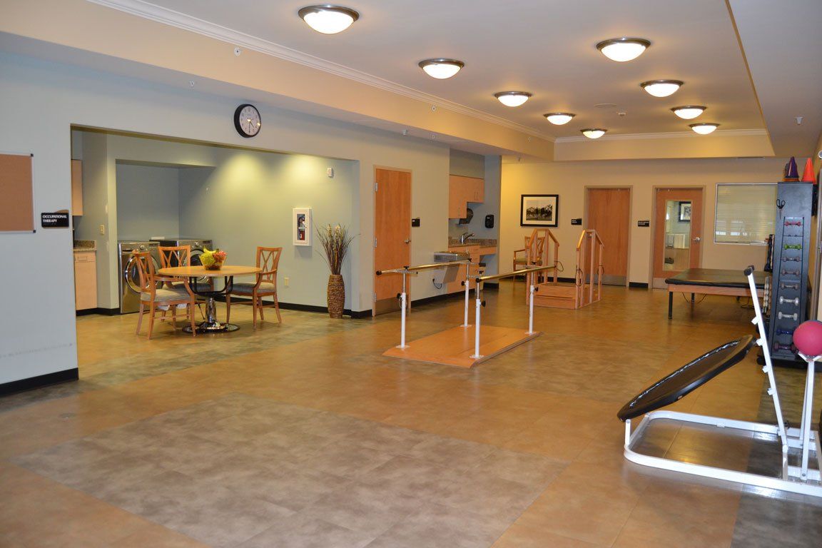 A large room with tables and chairs and a clock on the wall