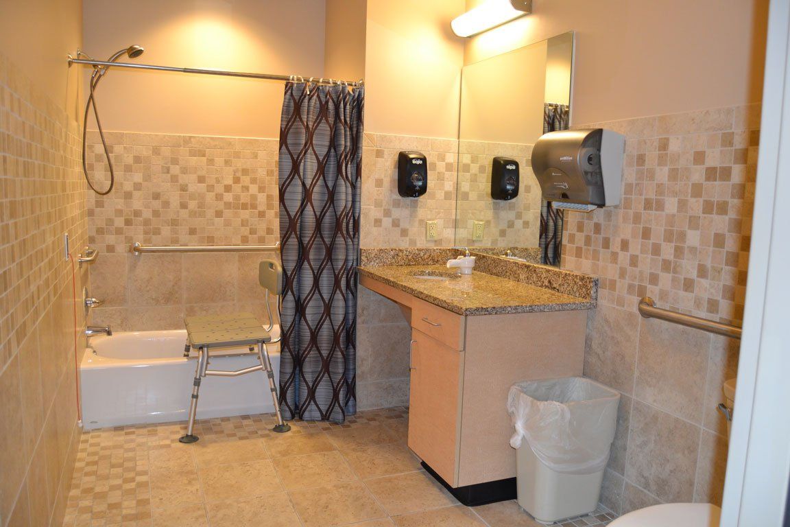 A bathroom with a tub , sink , toilet and shower.