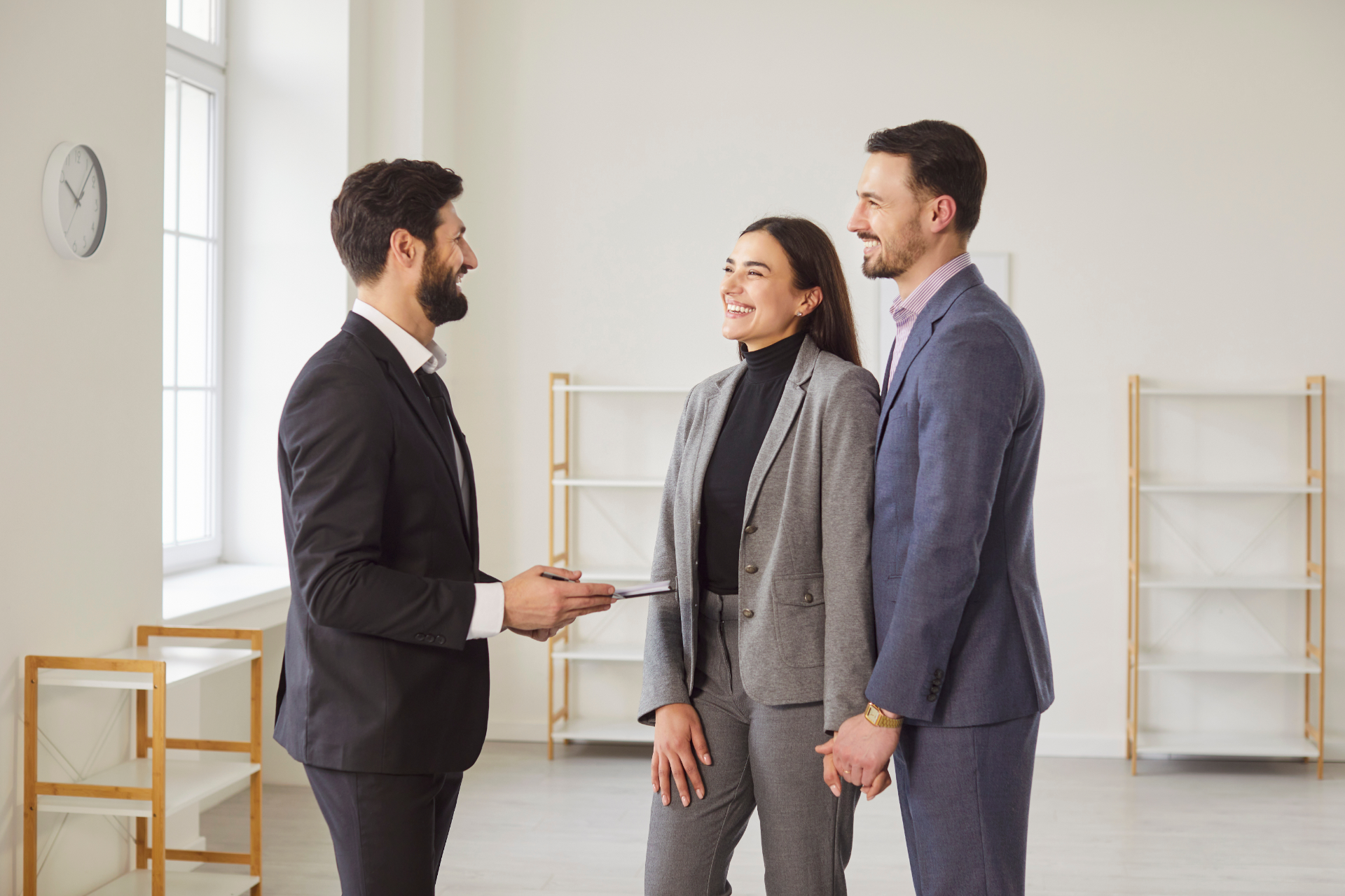A man in a blue shirt and tie is using a laptop computer.